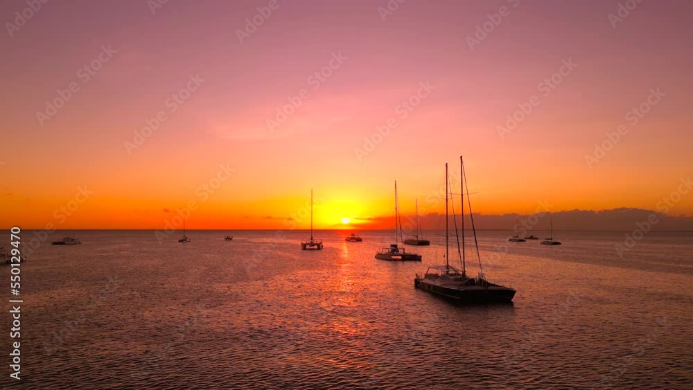 Silhouettes of moored at anchor sailing tourist yachts and catamarans at beautiful golden sunset. Silhouettes of moored at anchor sailing tourist yachts and catamarans at beautiful golden sunset.