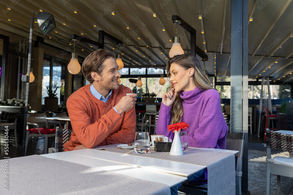 Beautiful couple drinking coffee in cafe bar Beautiful couple drinking coffee in cafe bar