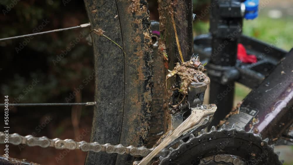 Cleaning bicycle gear on gravel bike with water after dirty ride Cleaning bicycle gear on gravel bike with water after dirty ride