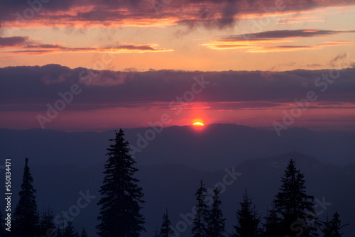 Fantastic evening winter landscape. Dramatic overcast sky