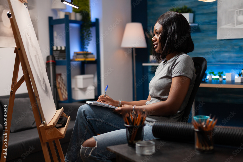 African american woman with artistic abilities appreciating completed ...