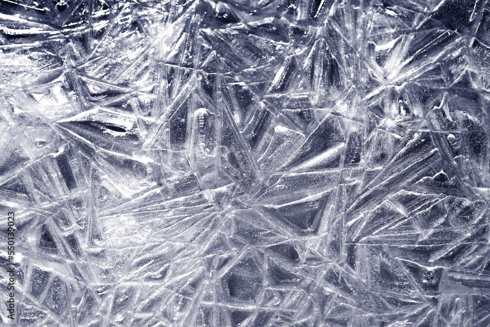 The texture of the ice surface. Winter background, festive background in the form of ice crystals. The texture of the ice surface. Winter background, festive background in the form of ice crystals.