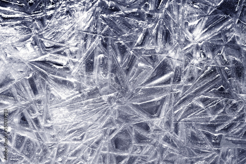 The texture of the ice surface. Winter background, festive background in the form of ice crystals.