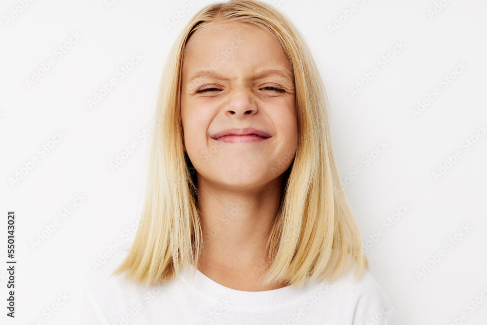 Little cute girl in a white t-shirt grimace cropped view Little cute girl in a white t-shirt grimace cropped view