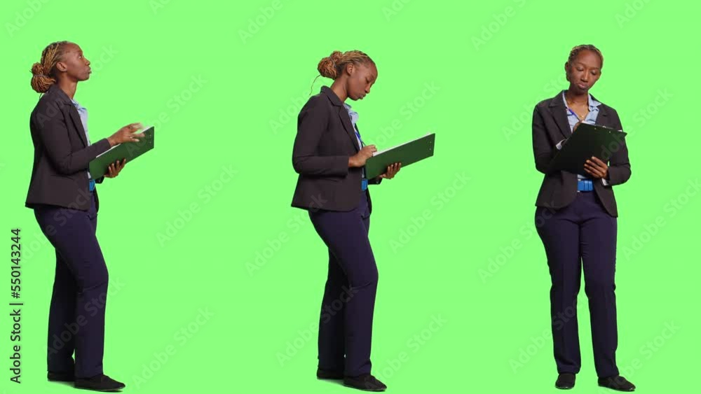 Business accountant taking notes on files over greencreen backdrop, writing information and company data on clipboard papers. Full body green screen of woman working as manager. Business accountant taking notes on files over greencreen backdrop, writing information and company data on clipboard papers. Full body green screen of woman working as manager.