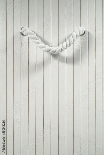 White wooden wall with thick rope handle