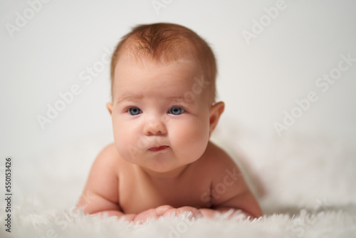 portrait of an infant with the emotion of a thinking person on a white background
