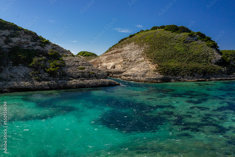 Fototapeta premium Natural landscape with mountain and blue sky, turquoise waters, eaux turquoises, lake, lac, paysage naturel avec montagnes et ciel bleu, Bonifacio, Corsica, Corse, France