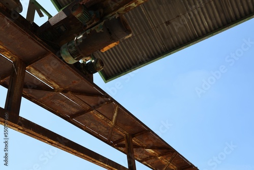 Rusty iron construction with an old engine in Beijing Erqi factoty with blue sky on the background photo