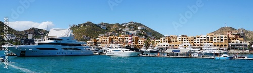 The panoramic view of the city with luxury boats, waterfront homes and resort hotels by the bay near Cabo San Lucas, Mexico 