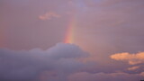 The colorful rainbow rising up in the sky after the summer rainning