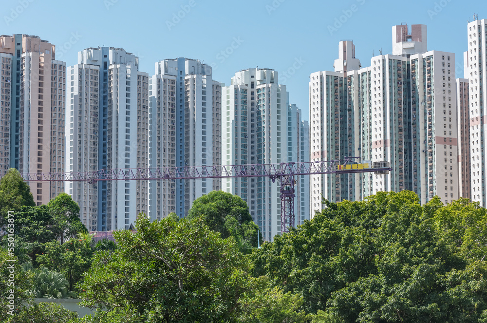 High rise residential building of public estate and crane in construction site in Hong Kong city