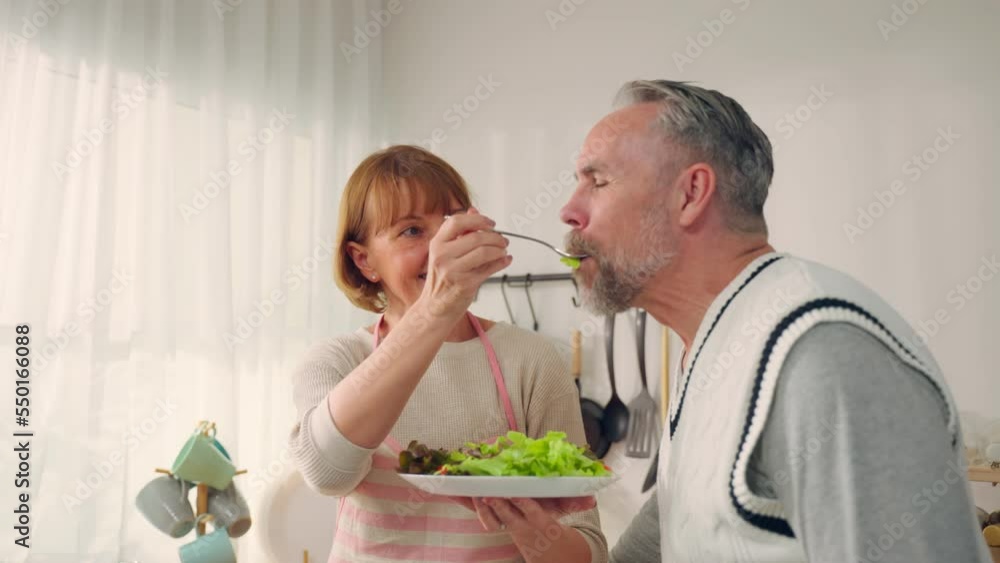 Caucasian senior elderly couple spend time together in kitchen at home. Caucasian senior elderly couple spend time together in kitchen at home.