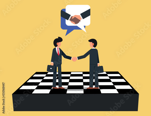 Consensus building and strategic partnership. Businessman firmly shaking hands standing on giant chess board