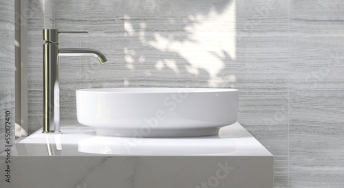 Modern and luxury beige bathroom vanity with white ceramic washbasin in dappled sunlight from window and leaf shadow on marble wall for personal and toiletries product display background photo