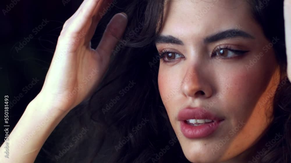 Beautiful woman in closeup with black curly hair and makeup, skincare commercial Beautiful woman in closeup with black curly hair and makeup, skincare commercial