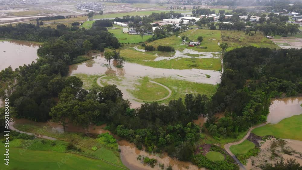 Residential neighborhood and flooded golf course in Australia - aerial pan Residential neighborhood and flooded golf course in Australia - aerial pan