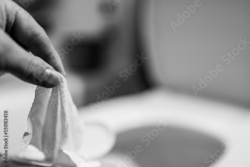 Disposable wipes being flushed down a toilet where they can cause clogging and problems with wastewater treatment. photo