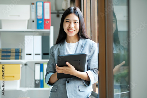 Young asian businesswoman working at office using laptop.