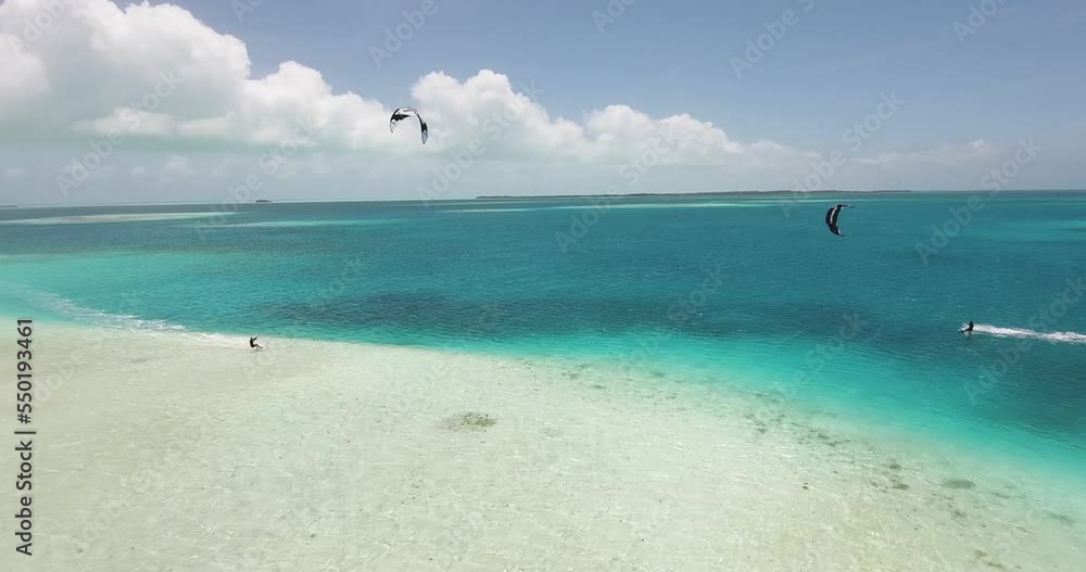 Two men kitesurf jump and cross Caribbean sea, drone shot Los Roques archipelago Two men kitesurf jump and cross Caribbean sea, drone shot Los Roques archipelago