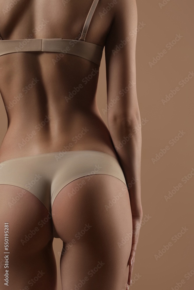 Thin young woman in underwear on beige background Thin young woman in underwear on beige background