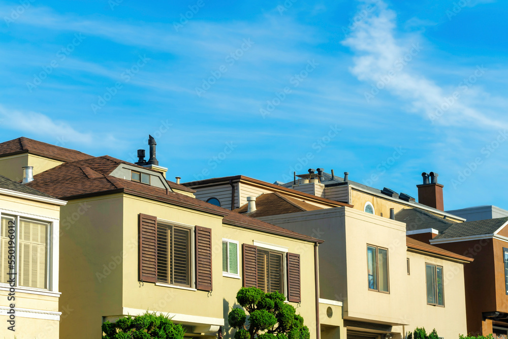 Fototapeta premium Row of houses in the late afternoon sun in a family neighborhood in San Francisco California