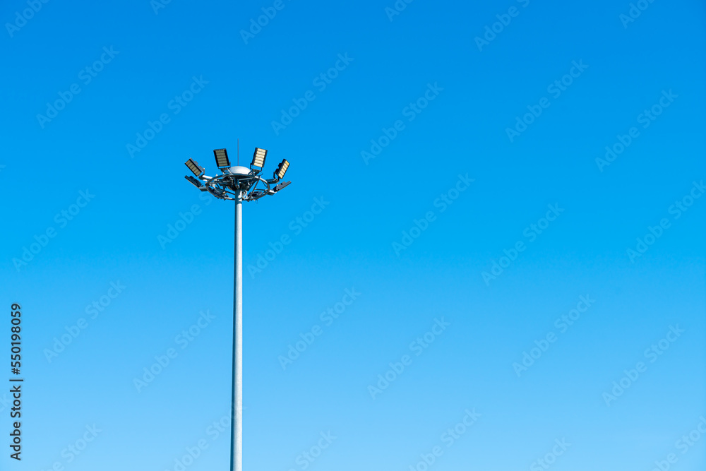 spotlight pole with blue sky
