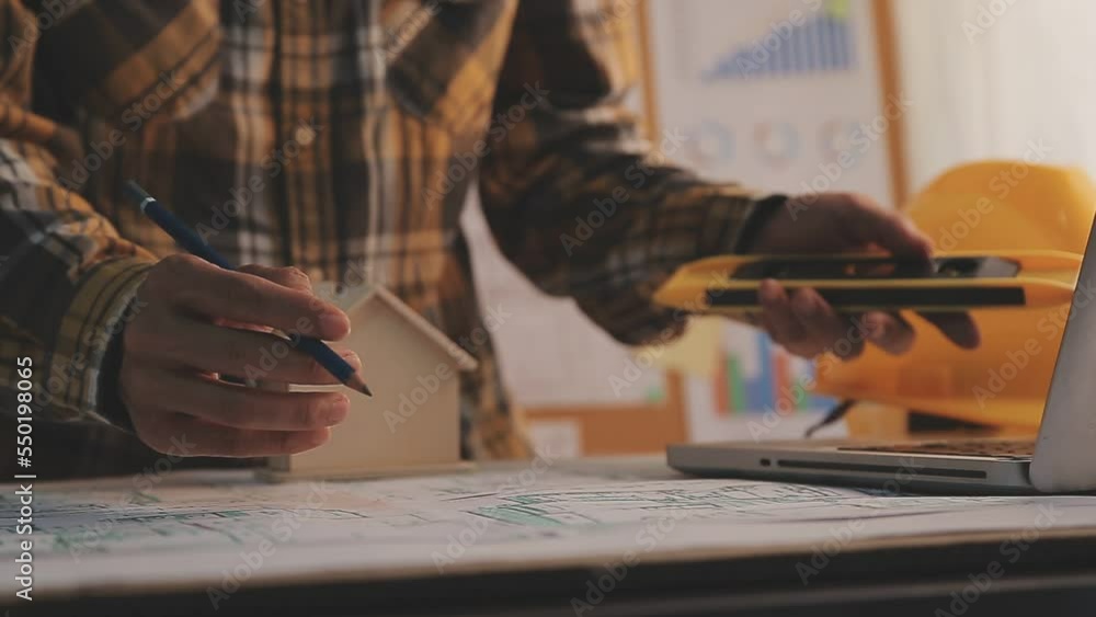 Construction engineer working at blueprint to build large commercial buildings in office. Engineering tools and construction concept. Construction engineer working at blueprint to build large commercial buildings in office. Engineering tools and construction concept.