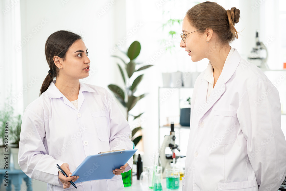 Scientists are taking notes. Happy teams of scientists experiment and research. international group of scientists. scientist teamwork. Scientists are taking notes. Happy teams of scientists experiment and research. international group of scientists. scientist teamwork.