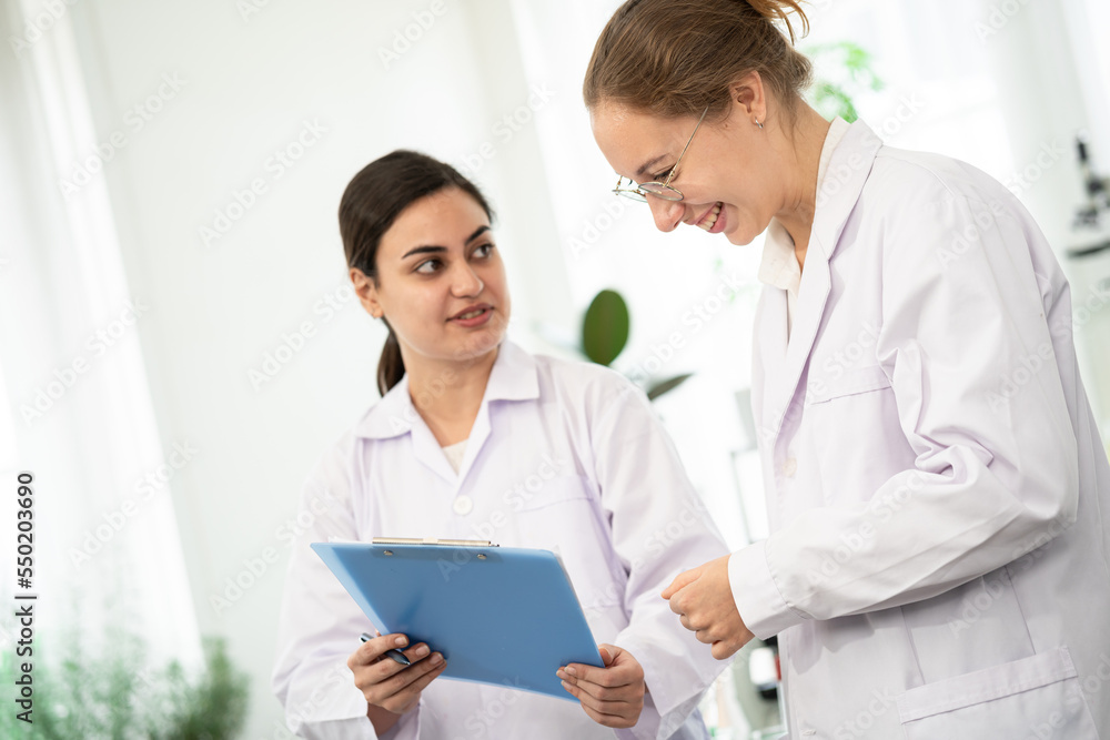 Scientists are taking notes. Happy teams of scientists experiment and research. international group of scientists. scientist teamwork. Scientists are taking notes. Happy teams of scientists experiment and research. international group of scientists. scientist teamwork.