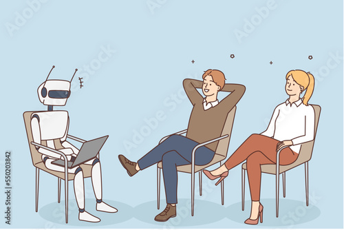 Businesspeople watch robot working on computer 