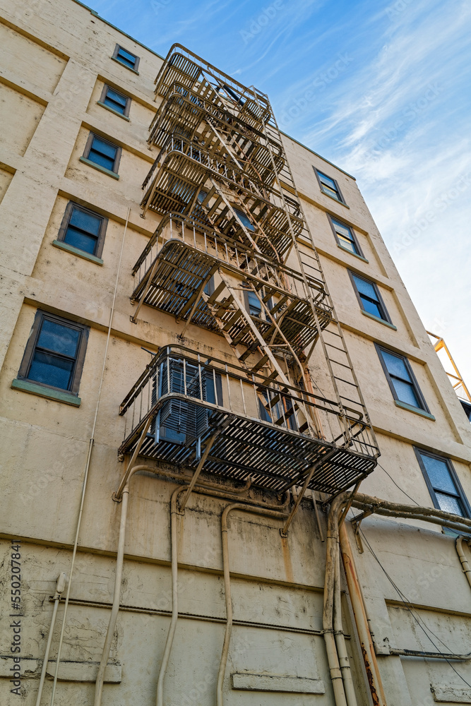 An upward view of the fire escape on the rear wall of a building