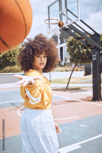 Sport, fitness and training basketball player catch ball, looking confident and tough on court. Portrait sporty woman enjoying time outdoors with favorite hobby, spending weekend on healthy activity photo