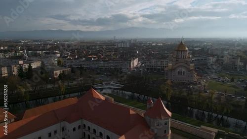 Wallpaper Mural Ascending aerial drone flight around with castle Cetatea Făgărașului and the Orthodox church Catedrala Sfântul Ioan Botezătorul of Făgăraș in România - bird view of Fagaras in Romania in winter 2022 Torontodigital.ca