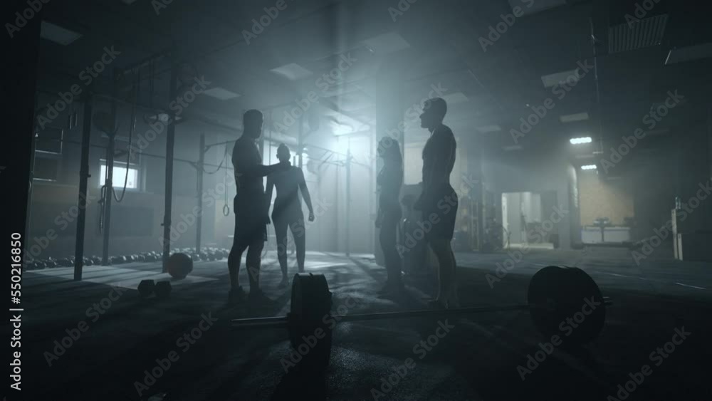 team in fitness club, people are hitting fists, symbol of friendship, male and female sportspersons