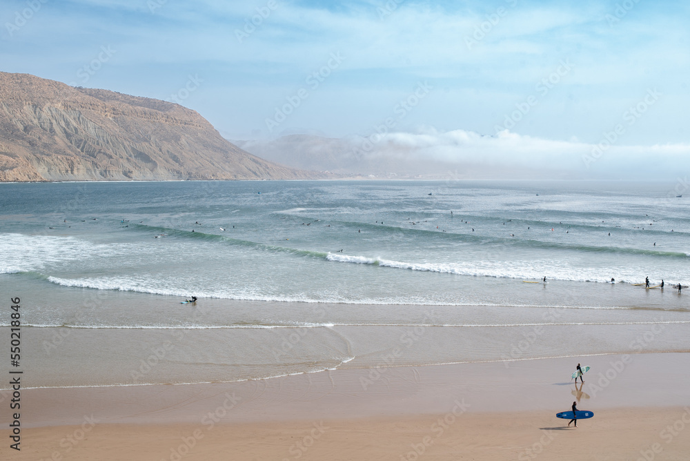 Longboard surfers on the beach at the longest wave of North Africa at Imsouane, Morocco Longboard surfers on the beach at the longest wave of North Africa at Imsouane, Morocco