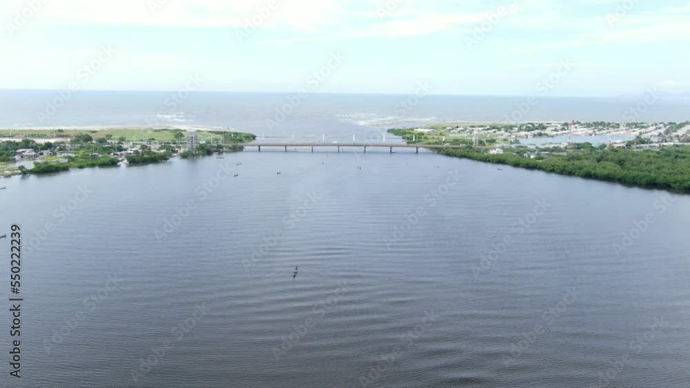 Drone shot establishing a bridge connecting two islands. Cienaga Magdalena city in Colombia. Drone shot establishing a bridge connecting two islands. Cienaga Magdalena city in Colombia.