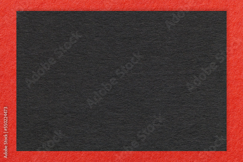 Texture of craft black color paper background with red border, macro. Structure of vintage kraft cardboard
