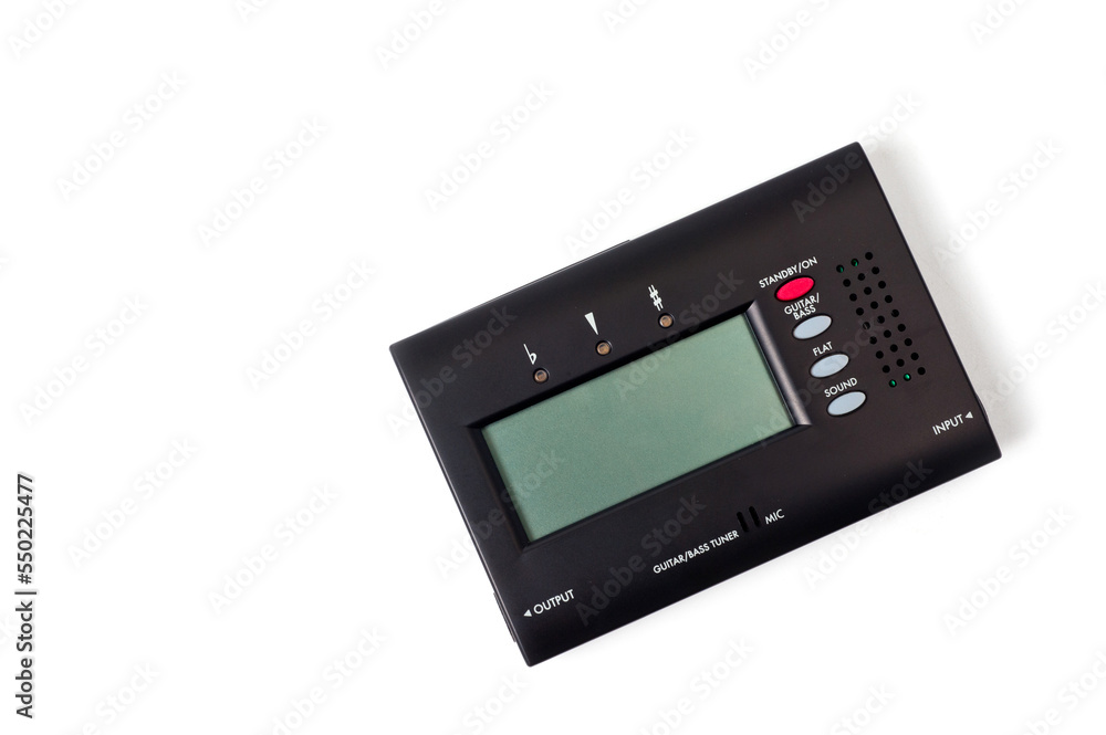 Tuner for tuning a bass guitar, compact, on a white background. Tuner for tuning a bass guitar, compact, on a white background.