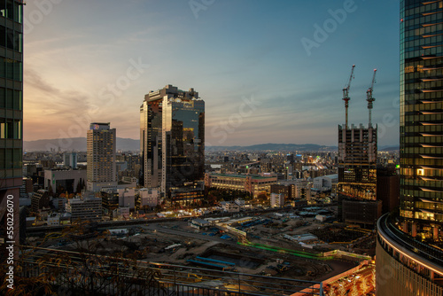 Beautiful sunset sky as lights come on in central Osaka towers