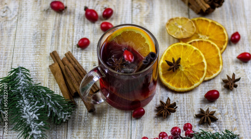 cups with hot mulled wine on a wooden background.