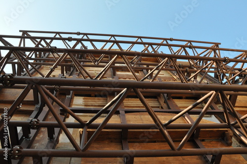 Low-angle shot of iron constructions to support houses after an earthquake