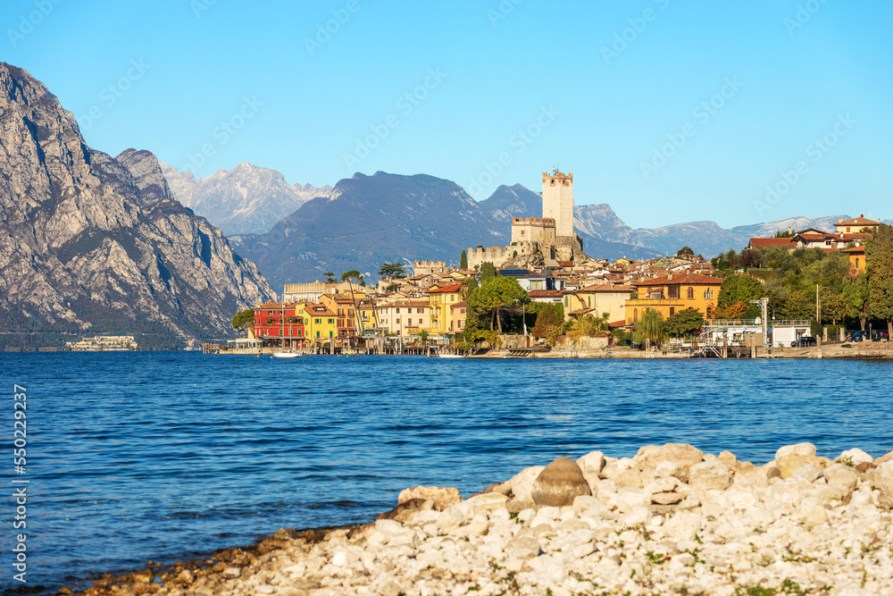 Lake Garda (Lago di Garda) and the small Malcesine village with the castle. Verona province, Italy, Veneto, southern Europe. On background the coast of the Lombardy.