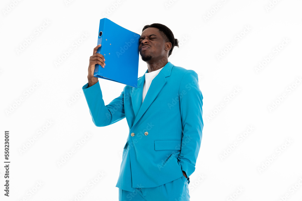 Portrait of african american man holding folder in arm showing angry emotions at camera posing in blue suit and white t-shirt standing on white background in studio isolated. Portrait of african american man holding folder in arm showing angry emotions at camera posing in blue suit and white t-shirt standing on white background in studio isolated.