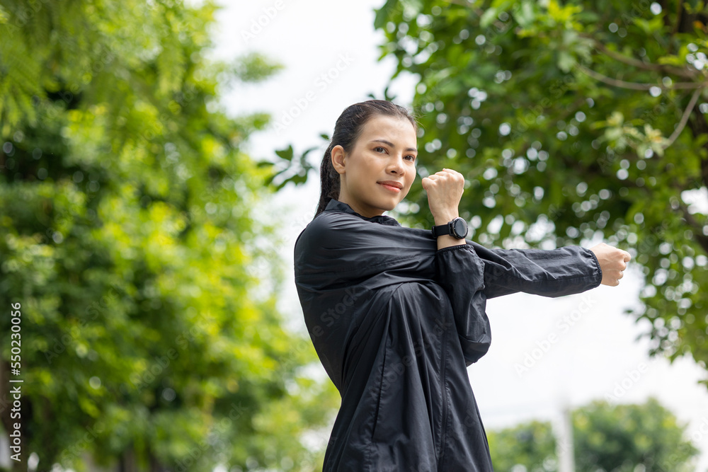 Beautiful asian woman wearing sportswear warming up before running. Confident and powerful woman stretching before Workout exercise in the morning. Healthy and active lifestyle concept. Beautiful asian woman wearing sportswear warming up before running. Confident and powerful woman stretching before Workout exercise in the morning. Healthy and active lifestyle concept.