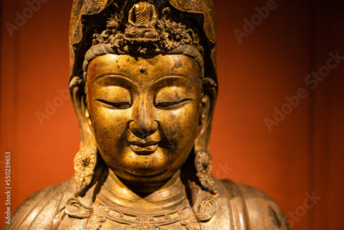 Statue of the buddha over the red background