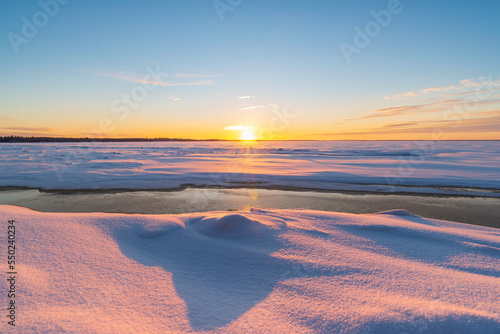 Sunset over the frosen sea. P  rken  s  Finland