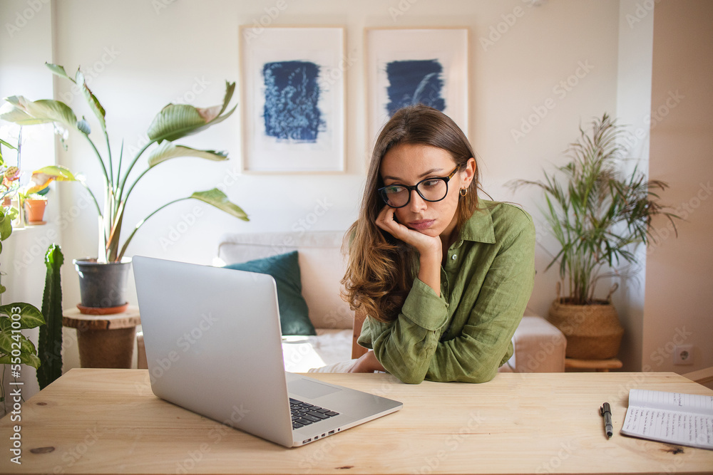 Woman bored and procrastinating working from home Woman bored and procrastinating working from home