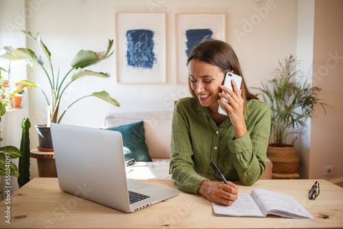 Woman working from home and talking on the phone