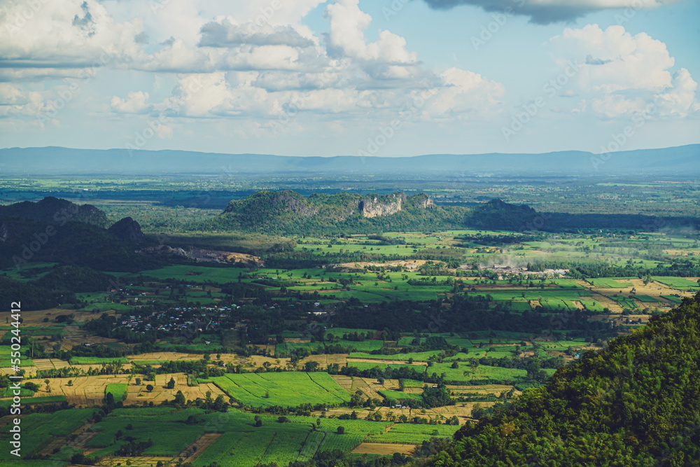 Obraz premium Picture from the highest point of Wat Khao Sam Yot. Phu Pha Man District Khon Kaen province with the sky, rice fields, mountains surrounding the countryside in Thailand.